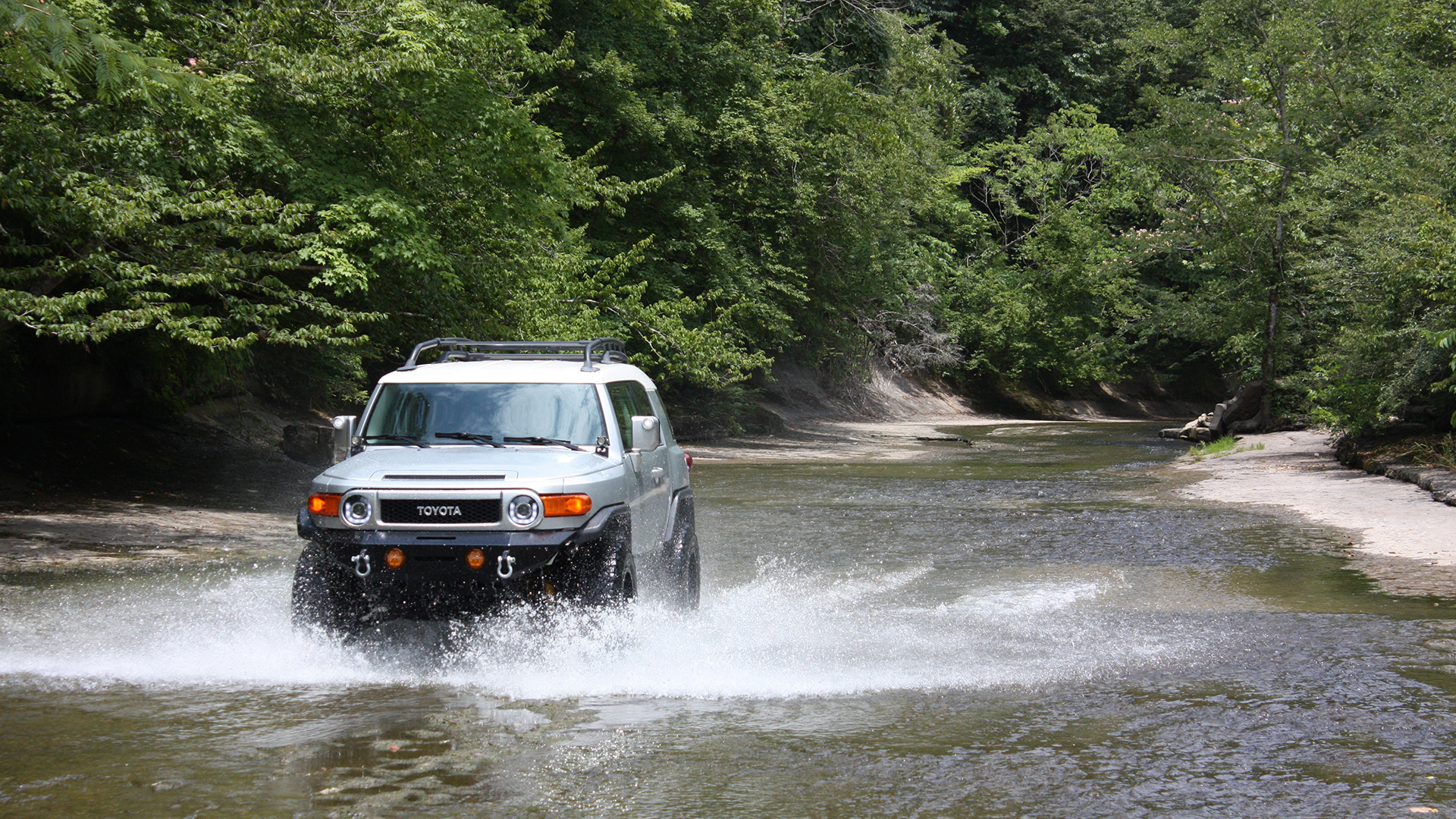 vehicle off-roading in a river